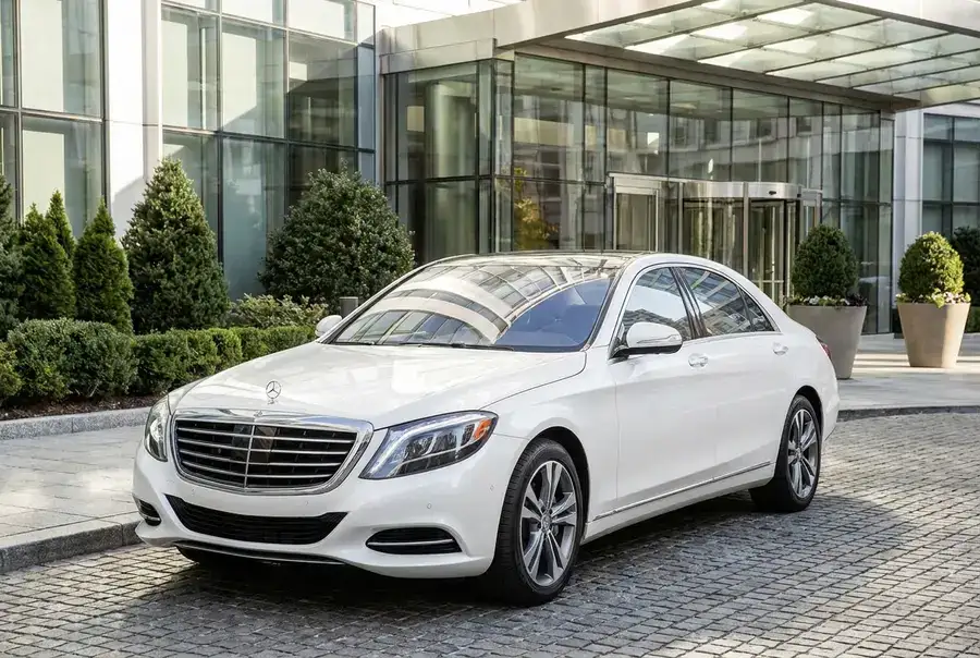 Pearl white luxury sedan, full front view