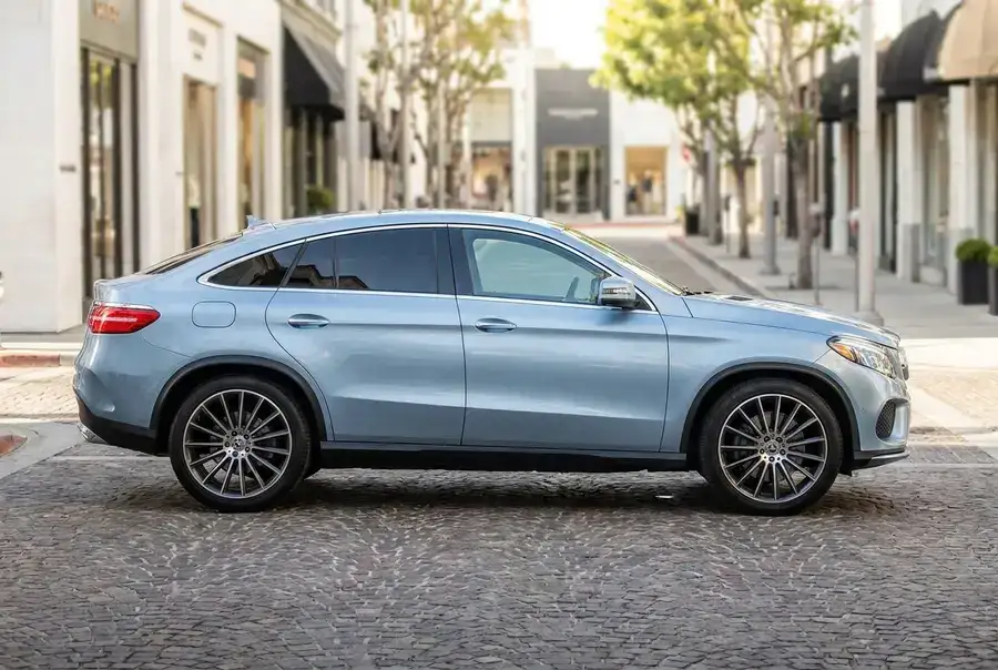 Light blue luxury coupe SUV in side view