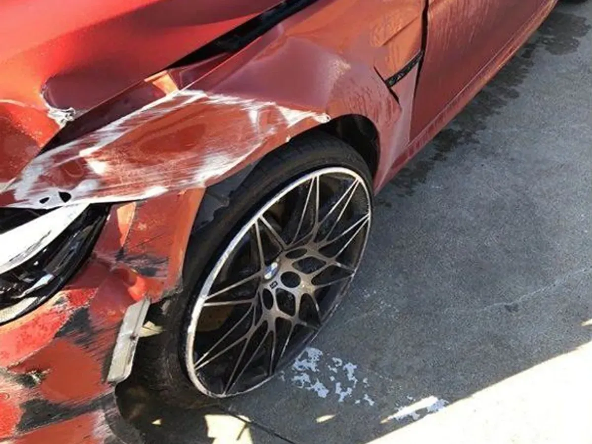 BMW M4 with collision damage — Front corner and wheel — before repair at F1 Collision, Van Nuys
