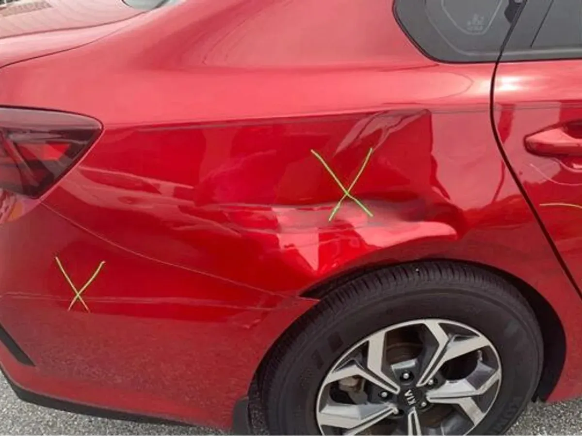 Kia Forte with collision damage — Rear quarter dent — before repair at F1 Collision, Van Nuys