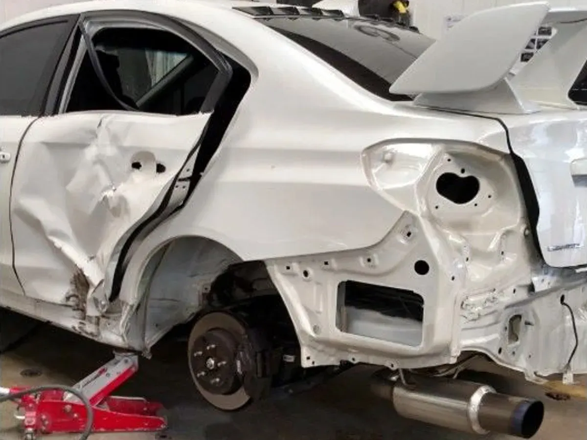Subaru WRX with collision damage — Rear quarter and door — before repair at F1 Collision, Van Nuys